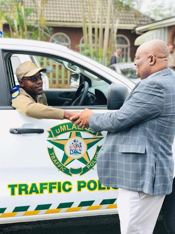 Superintendent Mbuso Biyela accepts a new traffic vehicle from Mayor Thelumoya Zulu. Biyela was shot dead with his service pistol on Friday afternoon.