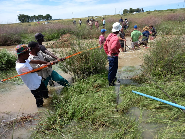 Ropes were tied together to try and reach the car, but the current was too strong.