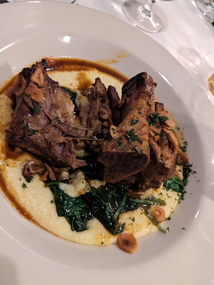 Pork shank with polenta and spinach