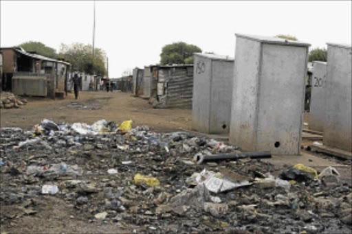 DISGUST: Residents reject the toilets built by the City of Johannesburg for the Holomisa camp settlement in Klipspruit, Soweto. PHOTO: MOHAU MOFOKENG