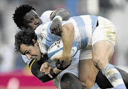 GRAPPLING WITH A PROBLEM: Lwazi Mvovo, pictured tackling Argentina's Nicolas Sanchez, is one of eight World Cup Springboks of colour