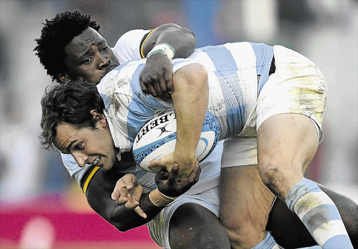 GRAPPLING WITH A PROBLEM: Lwazi Mvovo, pictured tackling Argentina's Nicolas Sanchez, is one of eight World Cup Springboks of colour