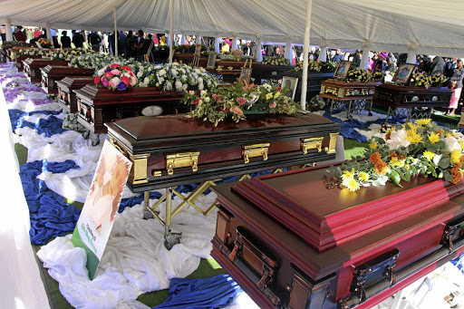 Coffins are lined up in two rows during the funeral service of 21 of the 24 victims of the collision between an overloaded minibus taxi and a bus June 16. The service was held in GaRapitsi Vilage in Kgapane at the weekend.