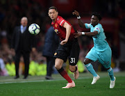 Nemanja Matic of Manchester United battles for possession with Christian Atsu of Newcastle United during the Premier League match between Manchester United and Newcastle United at Old Trafford on October 6, 2018 in Manchester, United Kingdom. 