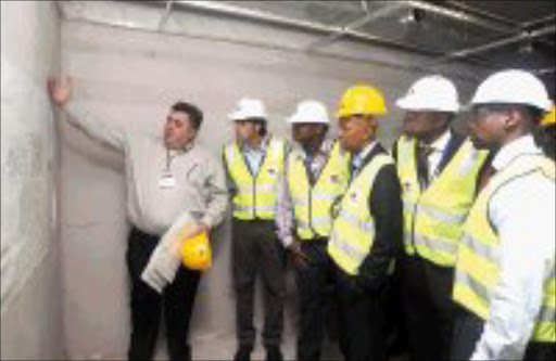 INSPECTION: Ellis Park Stadium architect Wynand Du Plessis, left, makes a point to Fifa's Alexander Klosterkemper, second from left, during the inspection of Ellis Park change rooms yesterday. Pic. Gavin Barker. 18/02/08. © Backpagepix.