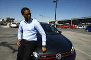 Race car driver Gugu Zulu  poses with his VW Golf at Nicholway shopping centre in Bryanston on 19 August 2013.