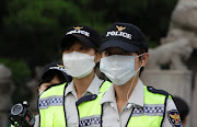 Policemen wear masks as a precaution to protect them against the MERS virus on June 10, 2015 in Seoul, South Korea. South Korea. Picture Credit: Getty Images