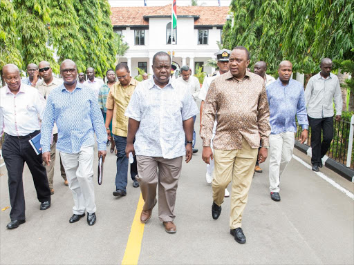 Fred Matiang'i and President Uhuru Kenyatta on the way to a security meeting at State House, Mombasa.