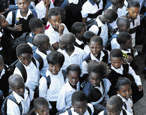 LET US IN! Pupils queue on the first day of school at the new ACJ Phakade Primary in Nomzamo, Strand, yesterday