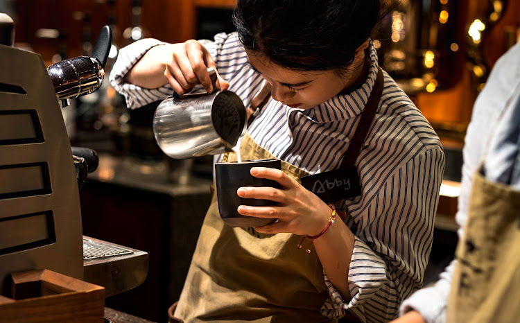 A barista prepares a coffee for a customer in Shanghai, China. Picture: 12RF/XIUXIU84