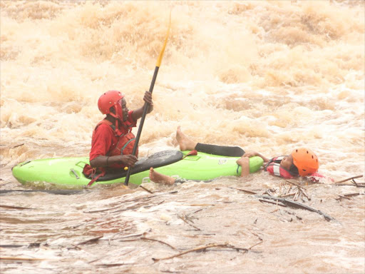 A life-saver tries to rescue a beginner in rafting at Sagana Savage Camp after her rafting boat capsized in May 2016.