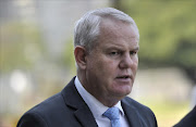 Cato Manor Organised Crime Unit head Major-General Johan Booysen leaves the Durban Magistrate's court on August 24, 2012 in Durban, South Africa.