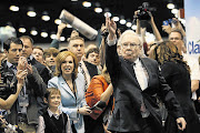 AIM HIGH: Berkshire Hathaway CEO Warren Buffett during a newspaper-throwing competition at the company's annual meeting in Omaha, Nebraska, which attracted more than 40000 shareholders.