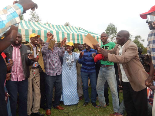 WATCHDOG WANTED: Jubilee leaders, including Kipchumba Murkomen (holding microphone), join party flag bearer Richard Leitich (in cap) in a dance during a rally in Kapkwen, Nyangores ward, Bomet county, on Monday.