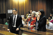 SHOW OF SUPPORT: Oscar Pistorius with family members during a break in proceedings in court yesterday