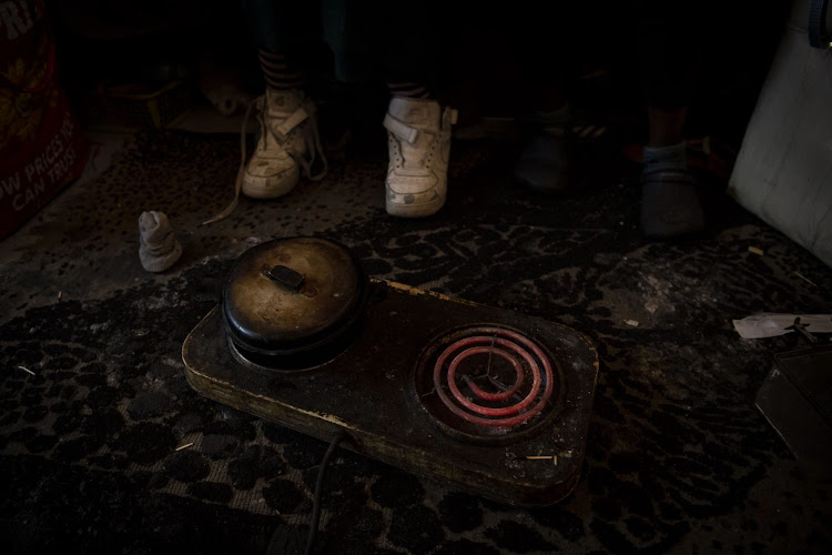 A two-plate stove heats up the room that four women share.