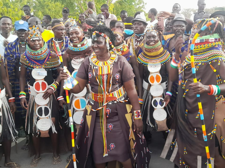 Turkana First Lady Lilian Ekamais (C) together with traditional dancers dressed in Turkana regalia at Lodwar airstrip awaiting to welcome President William Ruto on Wednesday, October 11, 2023.