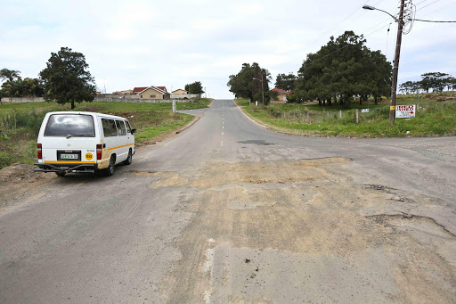 TICKING BOMB: Cars swerve onto the pavement to avoid a massive pothole in Amalinda, which has been partially filled with sand Picture: STEPHANIE LLOYD