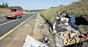 Flyers with pictures of King Goodwill Zwelithini litter the scene of the accident in which a car in the king's blue-light convoy collided with journalist Tim Ncube's car, killing him and the driver of the convoy car, Sergeant Thembinkosi Mpanza Picture: TEBOGO LETSIE