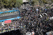 Iranians attend a rally marking Quds Day and the funeral of members of the Islamic Revolutionary Guard Corps who were killed in a suspected Israeli airstrike on the Iranian embassy complex in the Syrian capital Damascus, in Tehran, Iran, April 5, 2024. 