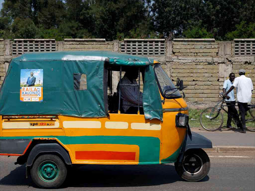 A man drives along a street in Kisumu with a poster of NASA presidential candidate on the vehicle, August 10, 2017. /REUTERS