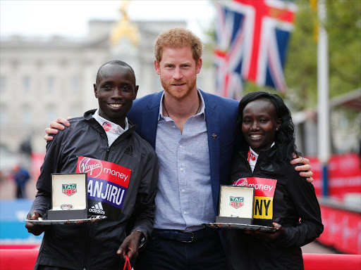 Prince Harry poses with Daniel Wanjiru and Mary Keitany after they won the London marathon races on Sunday, April 23, 2017. /REAUTERS