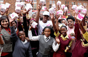 December 06, 2016. Caster Semenya donated menstrual cups and sanitary pads to the pupils of her former school at Fairlie village, Moletjie. She’s flanked by business-woman  Shamila   Ramjawan  and singer Candy Mokwena. Photo: SANDILE NDLOVU © Sowetan