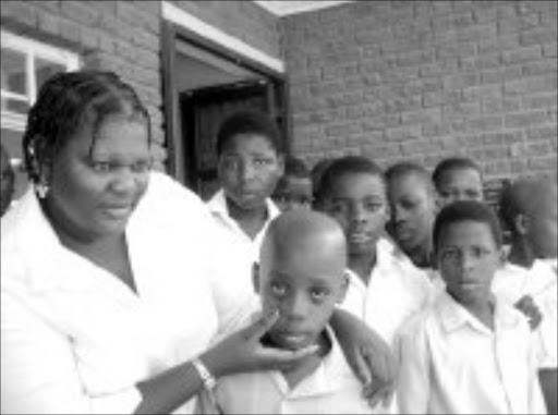 EYESORE: Sister Carol Mgwenya with Mpho Ndubazi(11), a grade 6 pupil at Maphakama Primary School who is suffering from an eye infection. Pic. Zenele Kuhlase. 15/01/2007. © Unknown