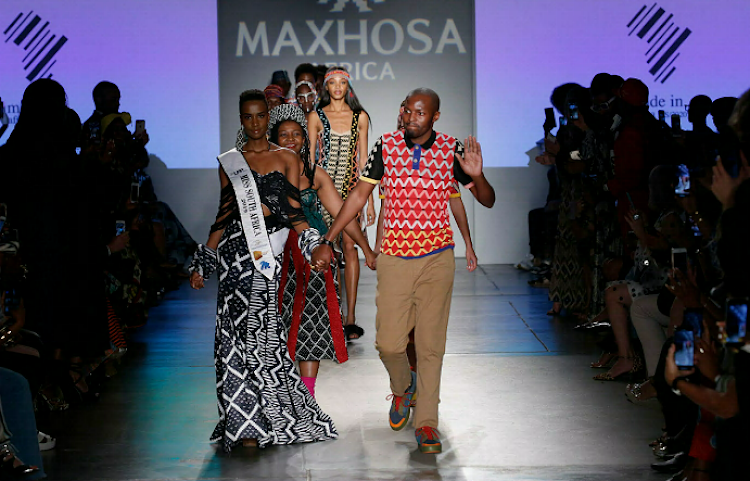 MaXhosa designer Laduma Ngxokolo walks the runway with Miss SA Zozibini Tunzi, who modeled one of his designs at this year's New York Fashion Week.