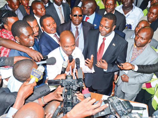 VICTOR: FKF presidential winner Nick Mwendwa (centre) with Sports CS Hassan Wario (to his immediate left) and outgoing FKF president Sam Nyamweya (behind him in dark glasses) after the elections at Kasarani Indoor Stadium. Photo/Eric Baraza