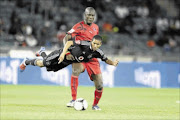 IN FLIGHT: Daine Klate of Pirates and  Elhadji Samb of   Cosmos fight for the ball at Orlando Stadium. Photo: Lefty  Shivambu/Gallo Images