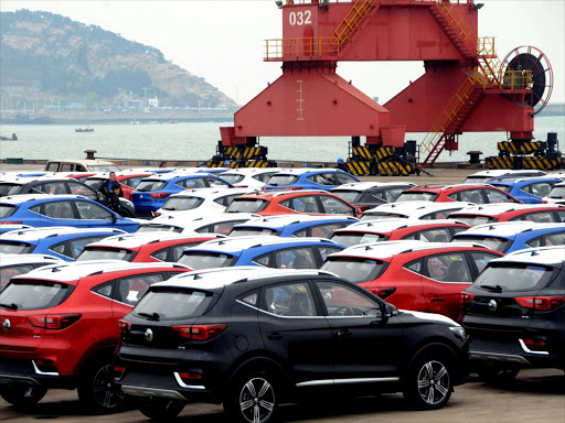 Sports utility vehicles (SUVs) await shipment/FILE