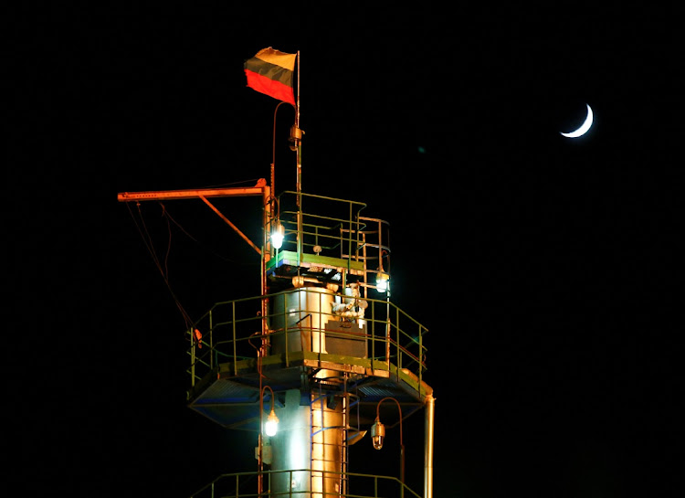 A Russian state flag flies on the top of a diesel plant in an oil fieldin Irkutsk Region, Russia. File photo: REUTERS/VASILY FEDOSENKO