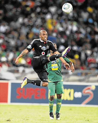 Orlando Pirates' Oupa Manyisa executes a flying kick during the Telkom Knockout semifinal match against Golden Arrows last week. Pirates face tough opponents before the festive break Picture: STEVE HAAG/GALLO IMAGES