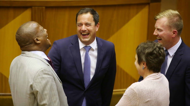 John Steenhuisen (centre) shares a light-hearted moment with ANC chief whip Jackson Mthembu and other National Assembly members in Parliament on February 15 2018.