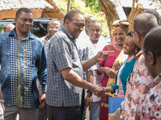 President Uhuru Kenyatta with Kenya Private Sector Alliance CEO Carole Kariuki when he arrived for the 2nd Annual Leadership Summit at Leisure Lodge Beach and Golf Resort in Kwale on Saturday /PSCU