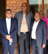 Chief Jeffrey Ramovha , c, police minister Fikile Mbalula, and Minister Des Van Rooyen during their visit at the Mulenzhe Traditional Authority Offices near Vuwani yesterday. PHOTO: ANTONIO MUCHAVE