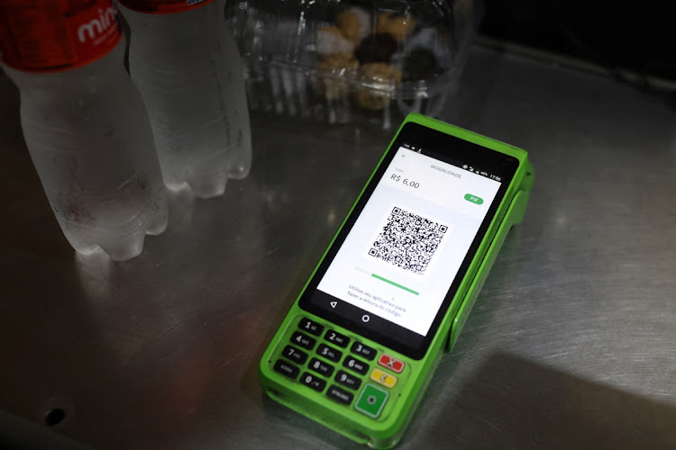 A QR code of the instant electronic payment mode known as PIX, is seen on a payment machine at a store in Rio de Janeiro. Picture: PILAR OLIVARES