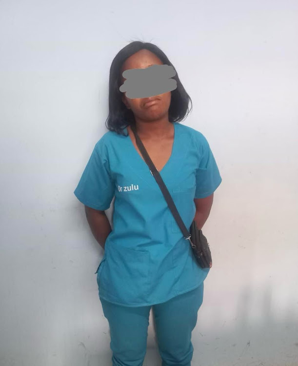 A woman apparently posing as a doctor was arrested while trying to solicit a bribe.