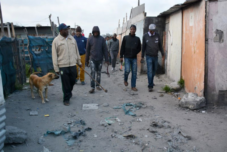 Community Police Forum (CPF) members patrol the Marikana informal settlement on October 03, 2017 in Cape Town.