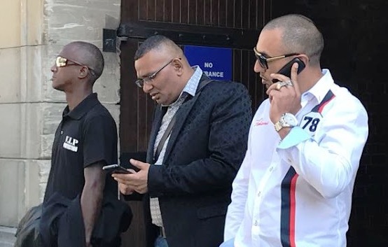 Colin Booysen, centre, and Nafiz Modack, right, after a previous appearance at Cape Town magistrate's court. They are accused of trying to extort a 'security' payment from a Cape Town business.