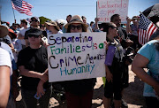 People protest against a recent US immigration policy of separating children from their families outside the Tornillo Tranit Centre, in Tornillo, Texas, on June 17 2018. 