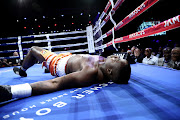 Justice Silinga lies on the canvas after being knocked out by Ruann Visser during  their SA & WBA Pan African Heavyweight bout at SunArena in Pretoria.