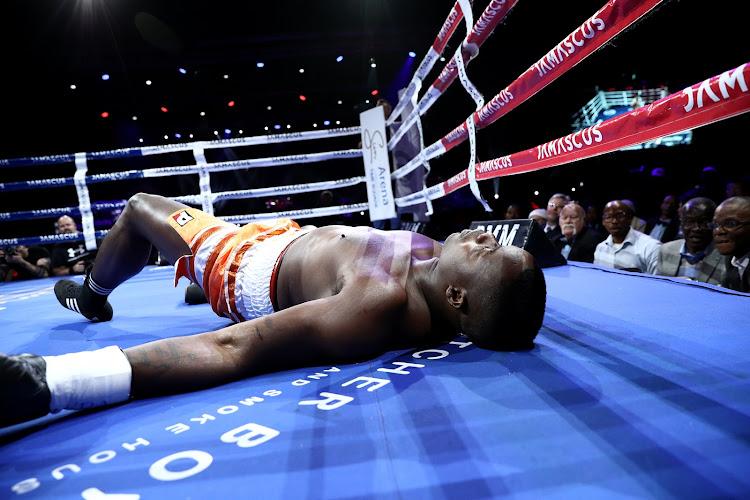 Justice Silinga lies on the canvas after being knocked out by Ruann Visser during their SA & WBA Pan African Heavyweight bout at SunArena in Pretoria.