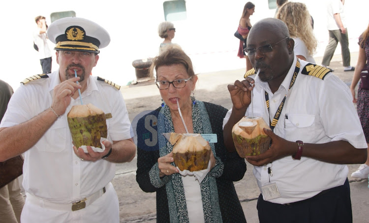 Capt Jan Master, Marti Fessenden and Capt Abdille Ali enjoying Madafu drink.