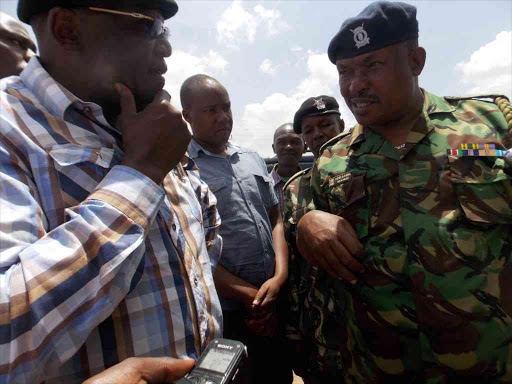 Machakos Senator Johnson Muthama and Athi River OCS Peter Kiema address the public, following a clash on a piece of land in Athi River, believed to belong to East African Portland Cement Company, February 24, 2017. /GEORGE OWITI