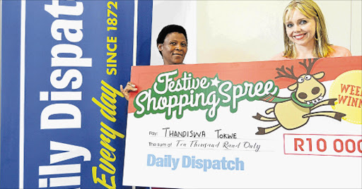 WINDFALL: This week’s winner of the Daily Dispatch Festive Shopping Spree of R10000 is Thandiswa Tokwe, who received her cheque from Dispatch acting marketing manager Penny Smith Picture: RANDELL ROSKRUGE