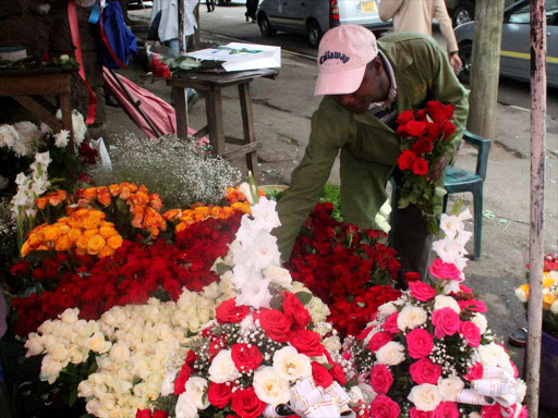 A vendor preparing his flowers for sale, February 10. /ENOS TECHE