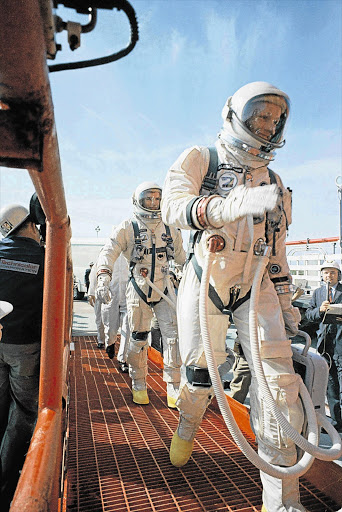 Commander Neil Armstrong, right, and pilot David R Scott board the Gemini-Titan VIII in this March 16, 1966 NASA file picture. The mission's aim was to conduct the first docking of two spacecraft in orbit. His craft landed safely back on Earth after an emergency abort. Armstrong, the first man to set foot on the moon, died on Saturday at the age 82 See Page 2 Picture: REUTERS/NASA