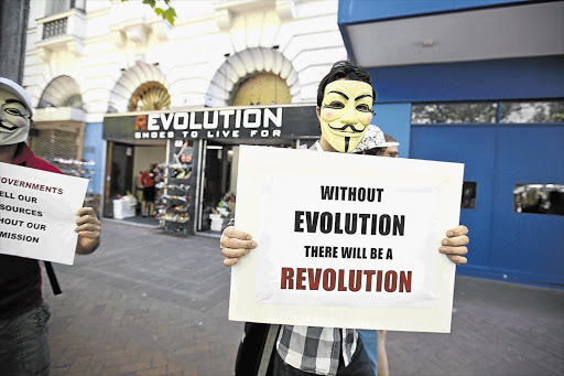 Supporters of Anonymous take part in the Million Mask March in Cape Town yesterday. Fewer than 20 people participated in the protest against corruption